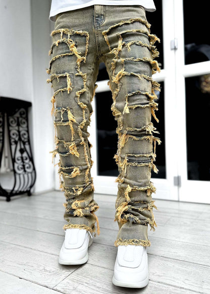 Trousers with fringes, rips and individual appliqués.